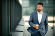 © JustLife - Portrait of handsome businessman. Businessman in blue suit drinking coffee