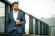 © JustLife - Portrait of handsome businessman. Businessman in blue suit drinking coffee