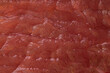 The texture of raw red meat close-up