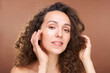 © pressmaster - Pretty young woman looking at you putting revitalizing patches on undereye zone