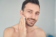 © Viacheslav Yakobchuk - Positive young man smiling before starting shaving procedure