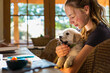 © Marc Romanelli - teen age girl holding her English Cream Golden Retriever puppy as she types on her laptop computer