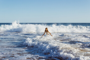 Poster - girl running from the waves on the beach