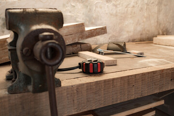 Various carpenter's tools on a wooden table ready for repair.