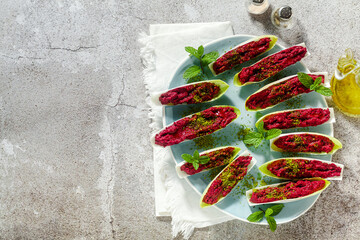 Wall Mural - dip of boiled beets and pistachios in leaves of Belgian Endive with mint. healthy summer snack