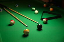 Billiard Background With Color Pool Balls And Cues On Green Table