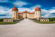 Castle Moritzburg located in Germany, Saxony region, near Dresden. Beautiful spring day with blue sky and white clouds. Surrounded by beautiful park