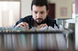 © FotoAndalucia - Man looking in a documentation file drawer