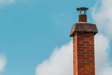 Red Brick Chimney And Cloudy Sky