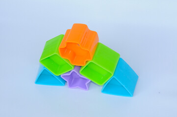 Isolated children's toy blocks in various shapes made of plastic on white background 