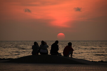 family on the beach at sunrise