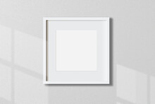 Minimal Empty Square White Frame Picture Mock Up Hanging On White Wall Background With Window Light And Shadow. Isolate Image