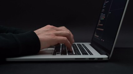 Wall Mural - person typing on laptop and programming development web working on black background