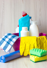 Household cleaning products on a light, dubious background, Cleaning the house, in the apartment.
A basin with cleaning products, rubber gloves and a brush. The concept of cleaning, disinfecting  home