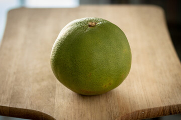 green orange fruit on a wooden table