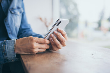 using cell phone.hand woman holding texting message on screen mobile chatting friend ,search internet information sitting in office.technology device contact communication connecting people concept