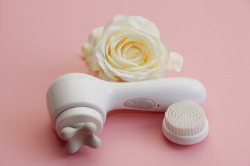 Wall Mural - massager for face lifting with a nozzle on a pink background