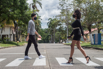  two young people crossing the street