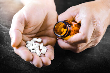 Wall Mural - Hand holding on open palm with pill tablets medicine for healing. Man takes medicines with glass of water