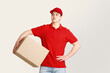 © Prostock-studio - Deliveryman expectation customer at door. Courier looks at free space and holds big box under his arm
