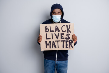 Wall Mural - Save black lives. Photo of mad dark skin african poor covid infected protester hold placard stand against black citizens lawlessness wear hoodie face mask isolated grey color background