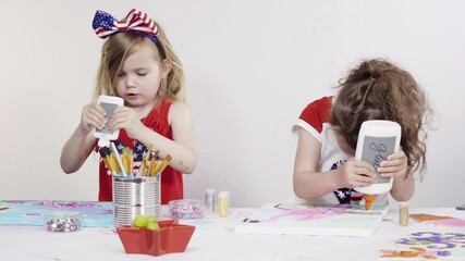 Poster - Little girls are painting on canvas on July 4th party.