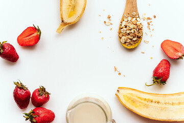 Wall Mural - top view of ingredients for smoothie or for porridge. bananas, strawberries, oatmeal, soy milk. proper nutrition concept. healthy food