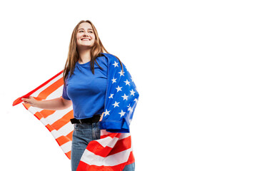 A young girl in jeans and a blue tank top holds an American flag and laughs. Celebrating Independence Day and patriotism. Isolated on a white background. Space for text.