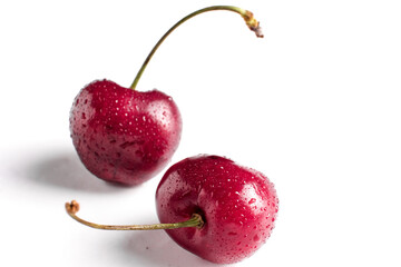 red cherry berry macro with drops of water at white background, isolated