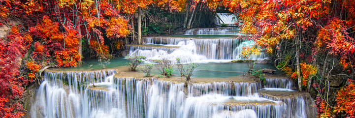  Beauty in nature, beautiful waterfall flowing of water with turquoise color of water in colorful autumn forest at fall season