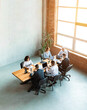 © Prostock-studio - Team Of Coworkers Working Together In Modern Office, High-Angle Shot
