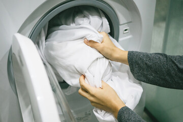 A woman puts the laundry