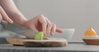 © GCapture - Man slicing ripe avocado on kitchen countertop side view