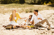 © Prostock-studio - Family Having Summer Picnic Sitting On Blanket Talking In Countryside