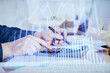 © peshkova - Financial trading graph multi exposure with man desktop background.