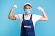© khosrork - Portrait of strong handyman in overalls, mask and cap showing biceps, profession of service industry, courier delivery, cargo transportation. Mover or logistic guy in workwear demonstrating strength