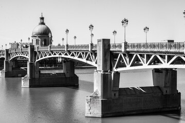 Wall Mural - Toulouse landmarks on the bank of river Garone. Hospital de La Grave and Ferries Wheel reflected in Garone river.