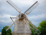 Fototapeta Dmuchawce - old wooden windmill in the countryside