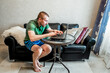 © toshket - A man works at home online on the Internet from a laptop