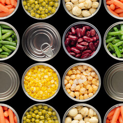 Wall Mural - Seamless food background made of opened canned chickpeas, green sprouts, carrots, corn, peas, beans and mushrooms on black background