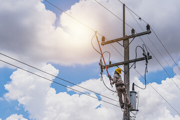 The power lineman use clamp stick (insulated tool) to closing a transformer on energized high-voltage electric power lines. The power lineman must be trained because it is a risky job.