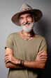 © luengo_ua - Style and vacation concept. Studio portrait of handsome senior man with gray beard and hat.
