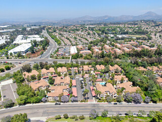 Aerial view middle class neighborhood with condo community and residential house and mountain on the background in Rancho Bernardo, South California, USA.