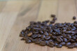 Selective focus of Roasted coffee beans on  wooden background with copy space.