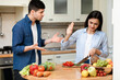 Young couple arguing in the modern kitchen at home