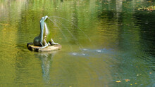 Gushing Seal Sculpture On A Park Pond.