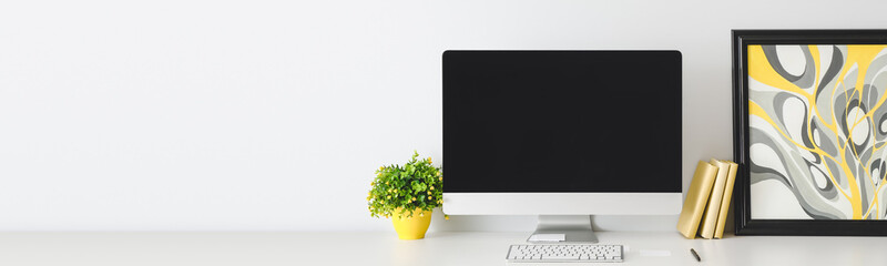 Modern workplace with computer near white wall with space for text