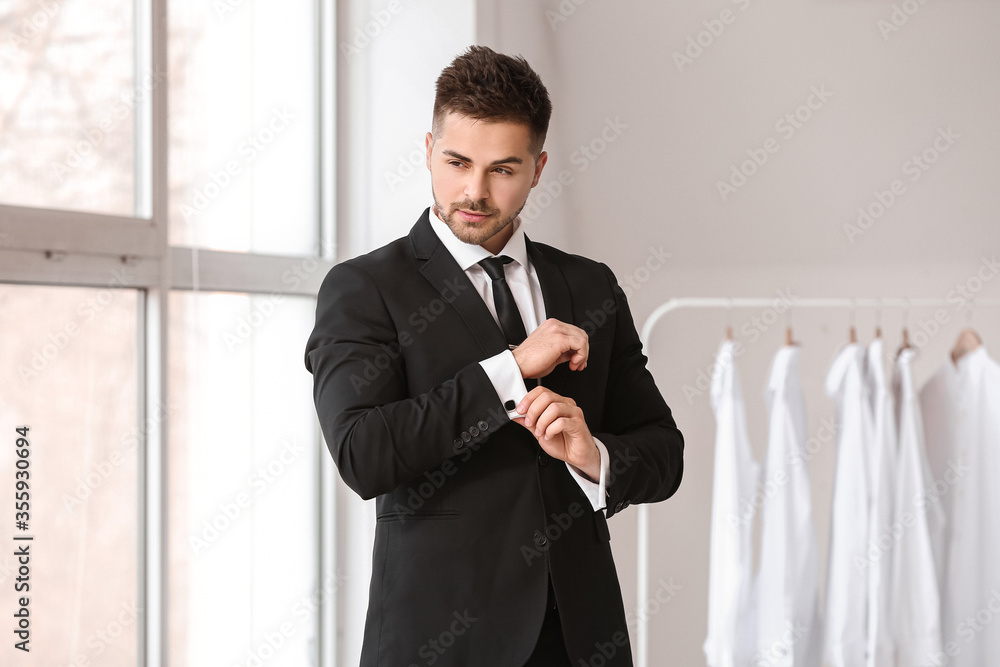 Handsome young man in elegant suit indoors