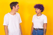 © carballo - young ethnic couple talking isolated on color background