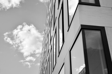 Urban geometry, looking up to glass building. Modern architecture, glass and steel. Abstract modern architecture design with high contrast black and white tone.